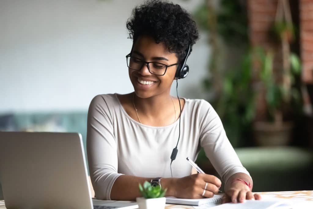 Smiling,African,American,Millennial,Female,Student,In,Headphones,And,Glasses
