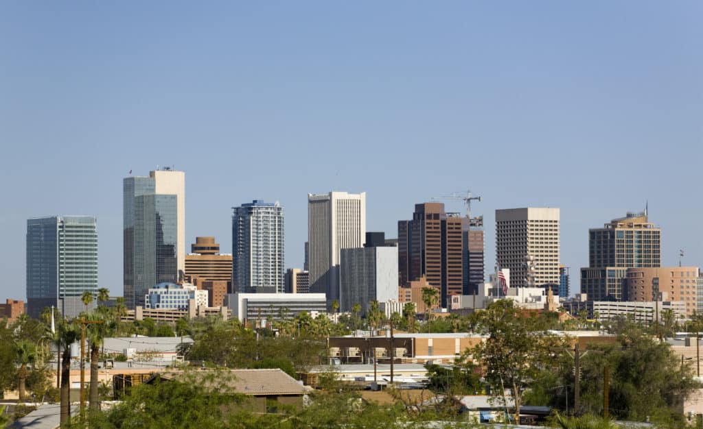 Downtown Phoenix skyline with high-rise buildings under a clear sky, representing the location served by Phoenix court reporters