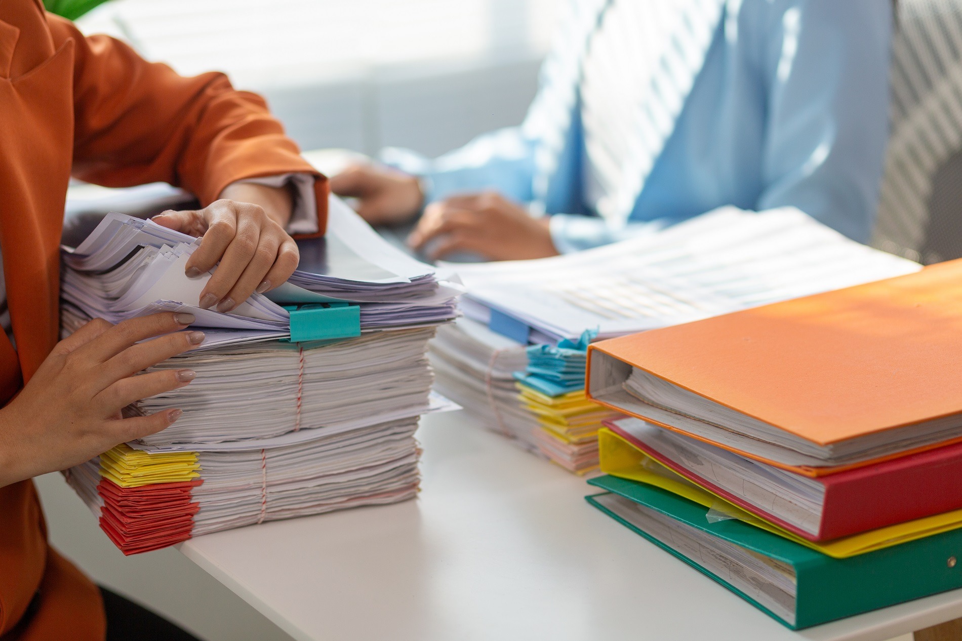 Large number of legal documents piled on the desk